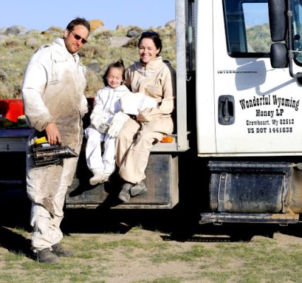 The family in bee suits beside the Wonderful Wyoming Honey truck